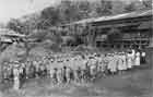 Japanese military personnel and nurses in front of the 8th Navy Hospital in Rabaul, c. 1943. After the town was isolated in 1944, the infrastructure for over 90,000 personnel was supported by extensive self-sufficiency efforts.