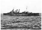 A battle-damaged HMAS Australia prepares to return to Leyte for repairs after being hit by five Japanese kamikaze aircraft over four days during the Luzon landings, Lingayen Gulf, Philippines, 9 January 1945.  Three officers and 41 ratings were killed and another 56 personnel were wounded in the attacks.  As the war drew nearer to Japan the appearance of kamikazes apparently confirmed the popular Australian perception of the Japanese as brain-washed fanatics. 