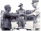 After signing the surrender documents, Lieutenant General ADACHI Hatazô hands over his sword to the General Officer Commanding the 6th Division, Major General H. C. H. Robertson.