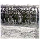 The 6th Division Australian Infantry Force stands at ease while ADACHI Hatazô marches past during the surrender.