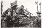 A soldier of the 2/8th Battalion provides covering fire with his Bren gun during the Australian assault on Mount Shiburangu, Wewak area, 27 June 1945.  Preceded by both an airstrike and a twenty-minute artillery barrage the attack was successful.  The Japanese bunker-complex was destroyed after three hours of fighting.  Two Australians were killed and four wounded while forty-four of the estimated sixty-strong Japanese garrison died trying to defend the position.  Small actions like this were typical of the final months of the War in New Guinea.