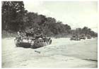 Matilda tanks of the Australian 2/4th Armoured Regiment rumble along the beach en route to Karawop Plantation during the Australian advance on Wewak, 21 May 1945.  The tanks provided the infantry with vital direct fire support and their ability to destroy Japanese machine gun nests and bunkers with impunity was greatly appreciated by the Australian infantry.  Lacking adequate anti-tank weapons the Japanese could do little to defend themselves against heavily armoured tanks like the Matilda.  Unfortunately for the Australians the further inland from the coast the more unsuitable the terrain became for tank operations.