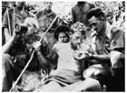 This famous photograph taken by Damien Parer on 22 September 1942 depicts Albert Moore (on the right) lighting a cigarette for the wounded Lieutenant Valentine Gardner at Menari. Albert was famous for his simple acts that provided welcome comfort to the troops in New Guinea.