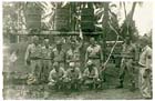 Sergeant Francis Bagley (standing, 5th from left) at Aitape, PNG, May 1944.  Note the 55-gallon drums rigged on a frame for cold water shower-use.