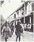 Japanese troops march through Labuan, Borneo 14 January 1942.  The ease with which the Imperial Japanese forces conquered Southeast Asia in early 1942 spurred the Japanese to enlarge upon their original war plan and attempt to isolate Australia.  New Guinea, which had barely figured in pre-war Japanese plans, would now become a key strategic objective.