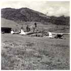 Allied planes on Wau Airstrip, which is interesting as it runs up the slope of a hill. The planes include a US Army Air Force Dauntless Dive Bomber (center), an RAAF Wirraway (left) and a US Army Air Force Piper Cub (right). Airstrips such as these were forward bases built in unorthodox terrain resulting from General Kenney’s ability to adapt to the conditions of New Guinea, a factor the Japanese command failed to do.