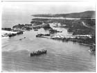The harbour and port installations of Finschhafen, 3 April 1944.  Captured by the Australians on 2 October 1943 the port facilities were not restored until the Huon campaign had all but ended.  Instead the seaborne lifeline needed to sustain the Australians in the field was maintained by the small landing craft and crews of the American 532nd Engineer Boat and Shore Regiment.  