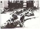 Japanese infantrymen of the Imperial Guard Division take up position on a street in Kuala Lumpur, Malaya, 11 January 1942.  The apparrent ease with which Japanese forces invaded and overran Southeast Asia in early 1942 convinced most Australians that their country was next.  Fear of invasion merged with old racial prejudices against Asians to create a hatred for the Japanese not found in Australian attitudes to their enemies in Europe.   