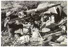 An Australian soldier inspects a blast-damaged Japanese Type 88 75mm medium anti-aircraft gun near the waterfront of Madang, 25 April 1944.  Australian troops had occupied Madang the previous day after patrols had confirmed that the Japanese had abandoned it.  Madang had served as a major Japanese base since 1942 and it's capture brought the Ramu Valley and Huon Peninsula campaigns to a close.