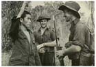 Two Australian soldiers guard a Japanese prisoner of war captured in the Ramu Valley, New Guinea, December 1943.